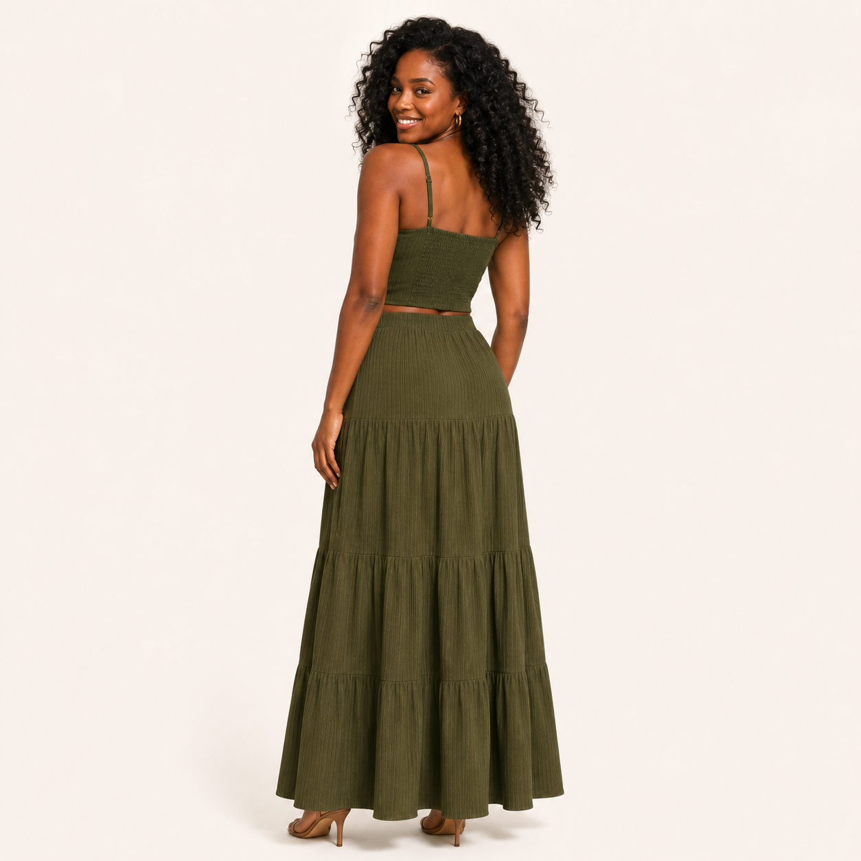 Back view of the olive green two-piece set, ribbed cami top and tiered maxi skirt, with a waist peekaboo where the pieces meet