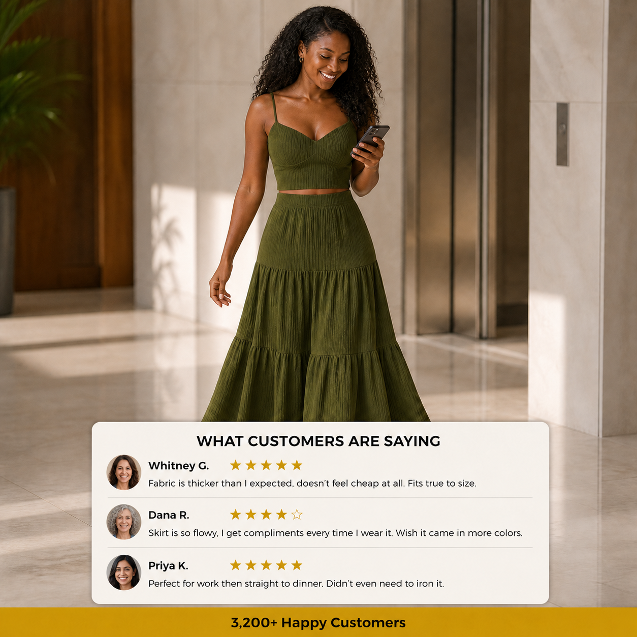 Woman wearing olive green two-piece maxi skirt set in an office lobby, checking her phone